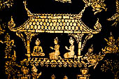 Wat Xieng Thong temple in Luang Prabang, Laos. Detail of the  intricate gold stencilling on black lacquer that decorate the walls of the sim. 